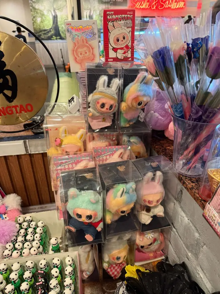 Fake Labubu dolls in clear plastic cases for sale at local Chinese restaurant
