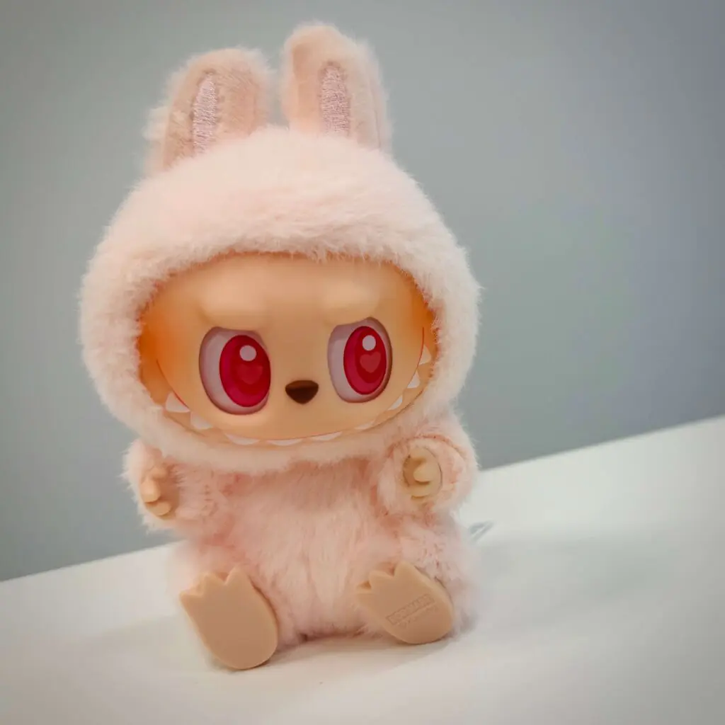 Labubu doll named Dada from Have a Seat V2 sitting down inside