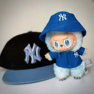 Labubu Hope clothes next to Yankees hat
