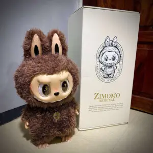 labubu zimomo doll i found you standing next to box on white table