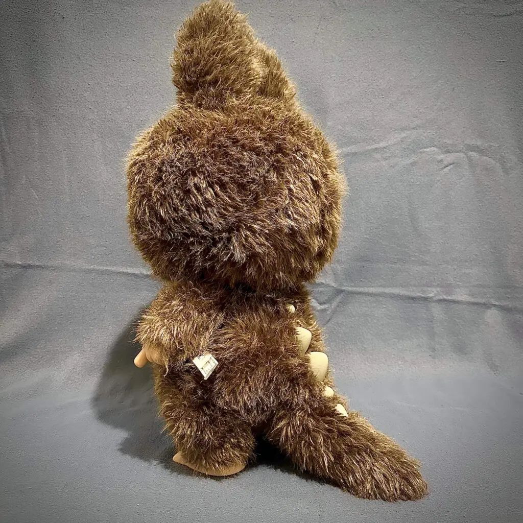 Side view showing table of large Labubu plush doll Zimomo showing the spikes on his tail