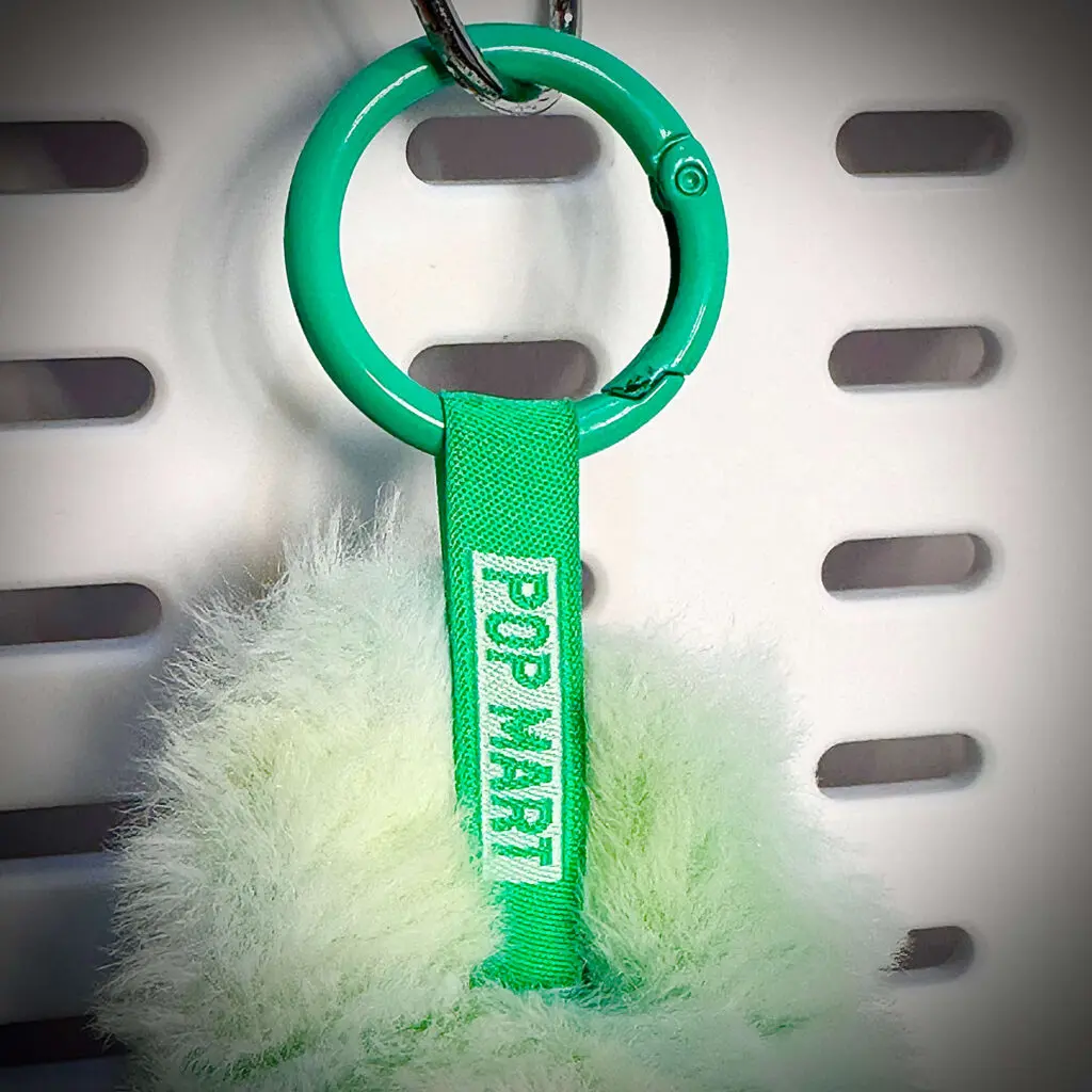 Closeup of lanyard of Labubu doll called Serenity showing Pop Mart engraving