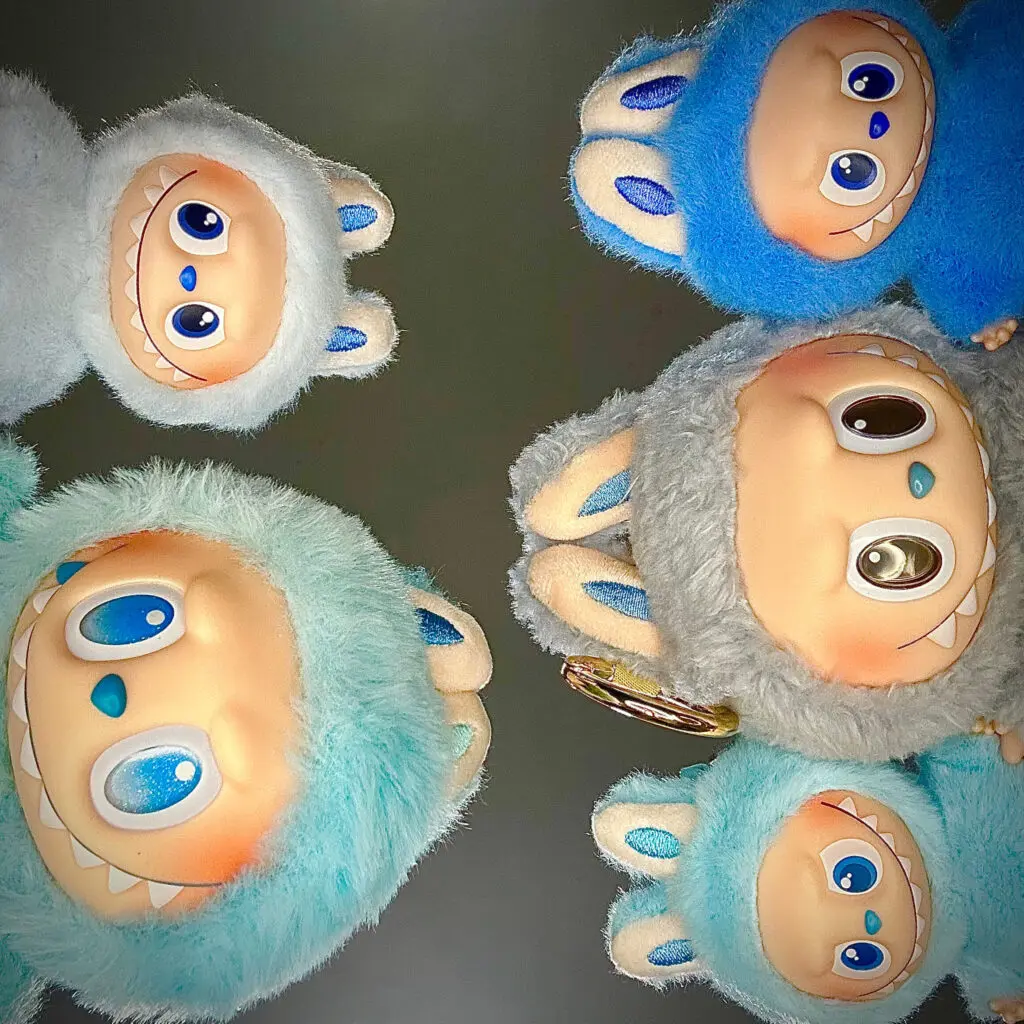 Cute picture of blue Labubu dolls looking down