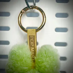 Back view of Labubu Green Grape pendant with embroidered branding