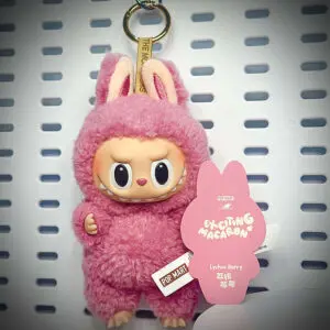 Labubu Lychee Berry doll from Exciting Macaron series hanging on a white pegboard with pop card