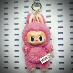 Lychee Berry doll from the Exciting Macaron series attached to a lanyard