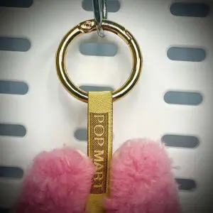 Back view of Labubu Lychee Berry pendant with embroidered branding