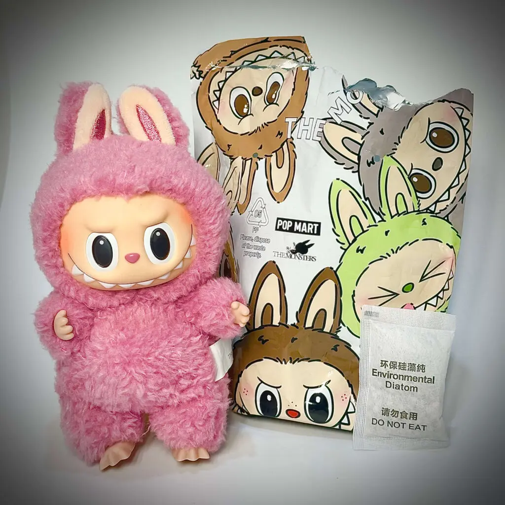 Labubu Lychee Berry beside its foil pouch packaging