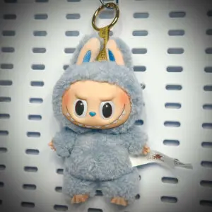 Labubu Sea Salt Coconut doll from Exciting Macaron series hanging on a white pegboard