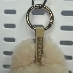 Back view of Labubu Soymilk pendant with embroidered branding