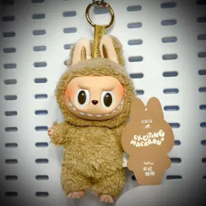Labubu Toffee doll from Exciting Macaron series hanging on a white pegboard with pop card