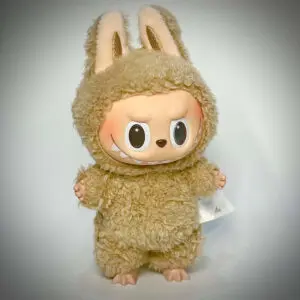 Labubu Toffee from Exciting Macaron standing in spotlight in white background with vignette