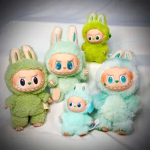 Group photo of 5 green Labubu standing on white table