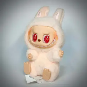 Labubu Dada from Big Into Energy sitting and under spotlight in white background