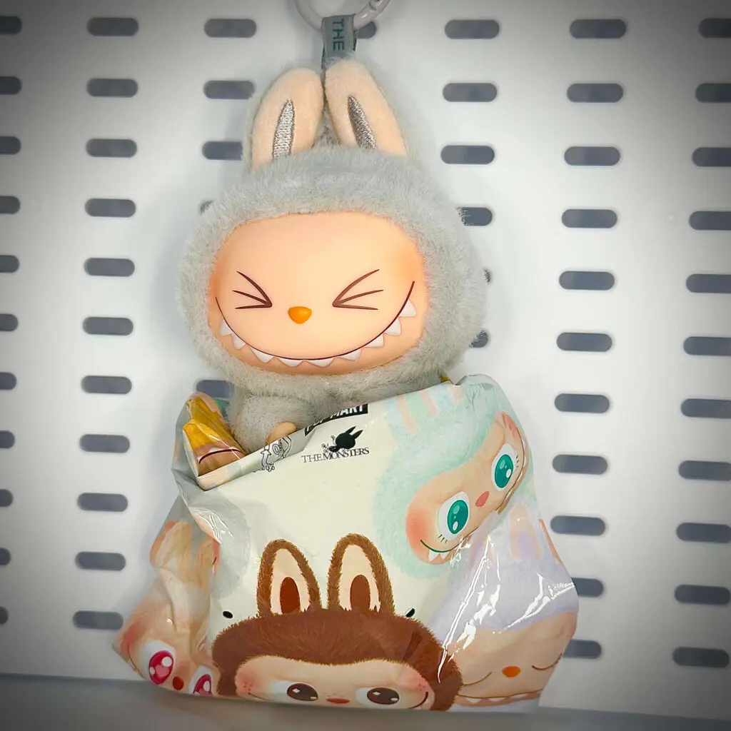 Labubu Hehe figurine inside its foil pouch packaging