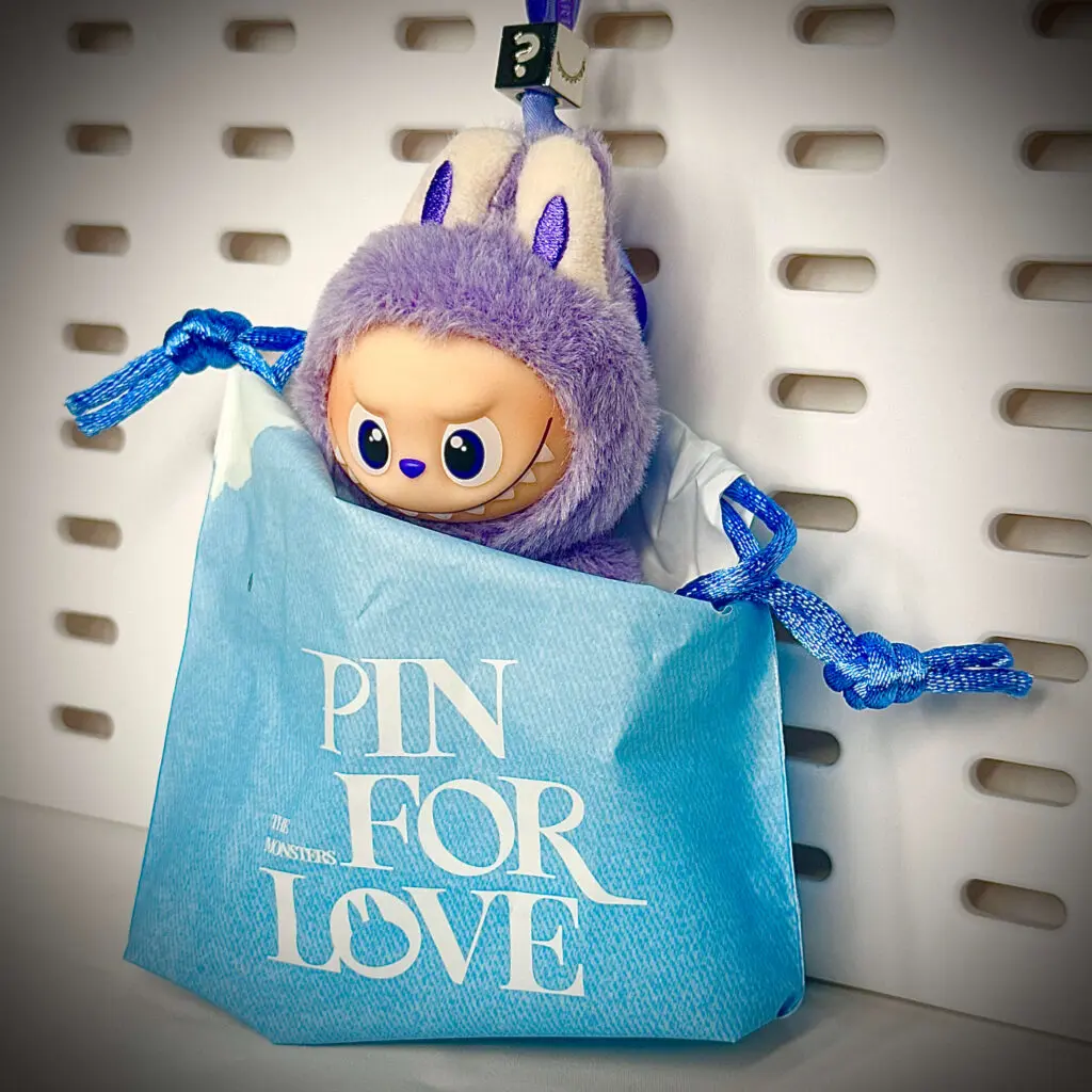 Mini Labubu Pin For Love Emm ? inside its drawstring pouch packaging
