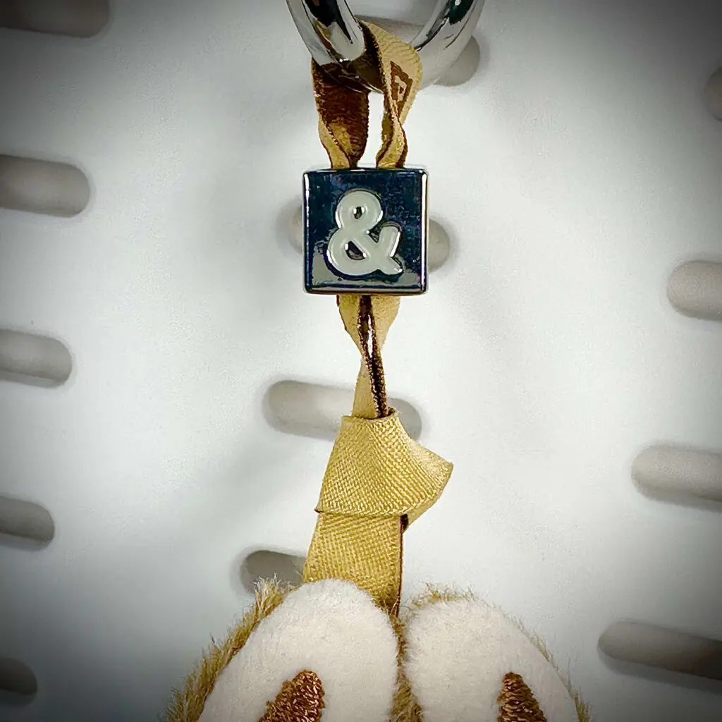 Close-up of Mini Labubu Pin For Love Motivation And & pendant with embroidered lanyard and alloy nugget