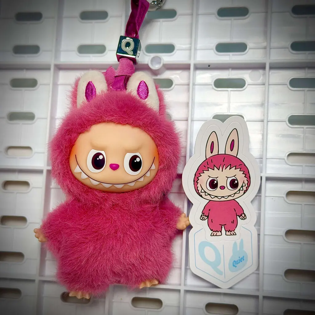 mini labubu pin for love q hung with sticker name