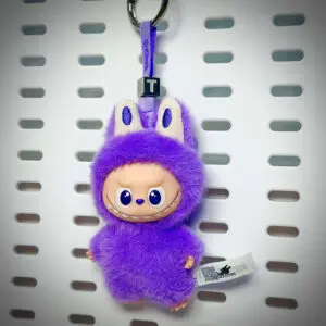 Labubu Pin for Love T Trust hanging on a board