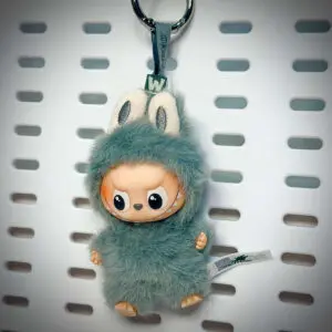 Labubu Pin for Love W Win hanging on a board