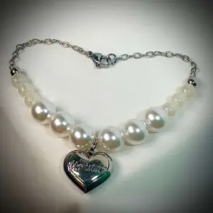 rock the universe labubu necklace under spotlight showing heart shape pendant