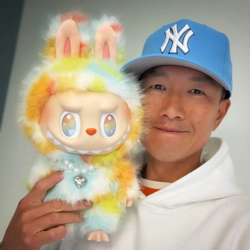 Selfie of Simon Chan w large labubu plush doll named Rock the Universe