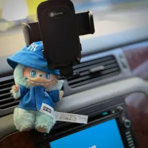 Labubu Hope wearing a matching blue New York Yankees baseball outfit inside the car