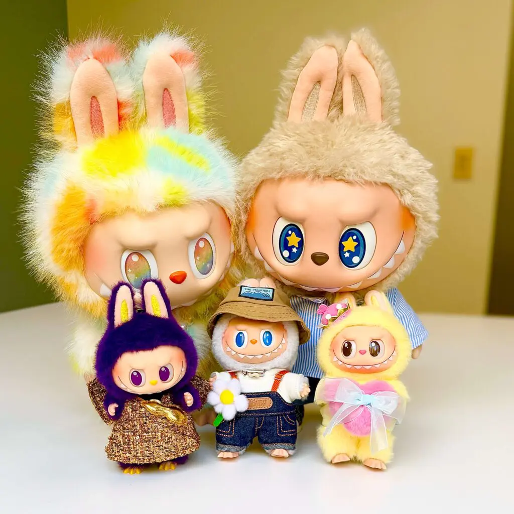 Labubu big plush dolls standing behind three key chain dolls