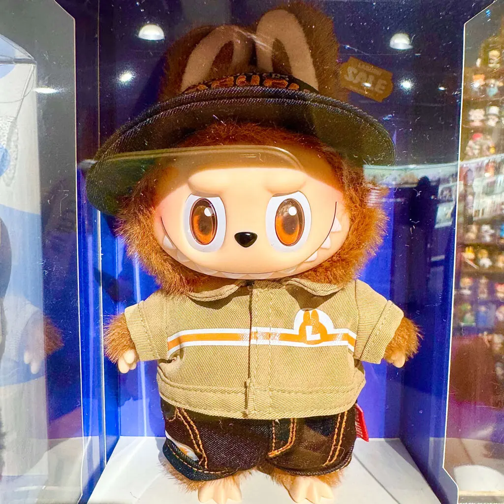Labubu Wacky Mart keychain doll inside a glass store display