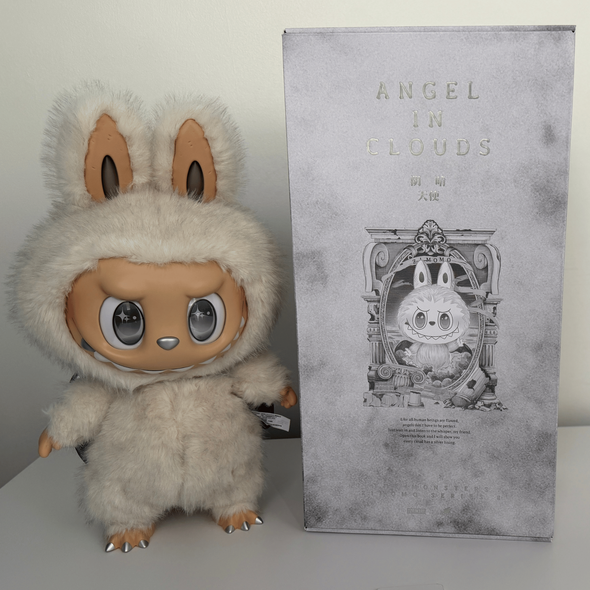 Labubu Zimomo Angel In Clouds plush doll beside box packaging