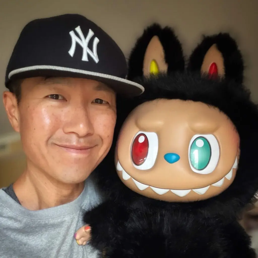 selfie of labubu zimomo 10th anniversary doll and Simon Chan