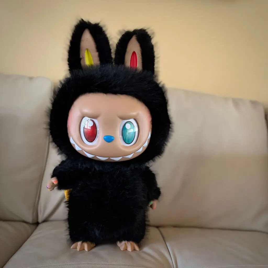 labubu zimomo 10th anniversary doll standing on white sofa