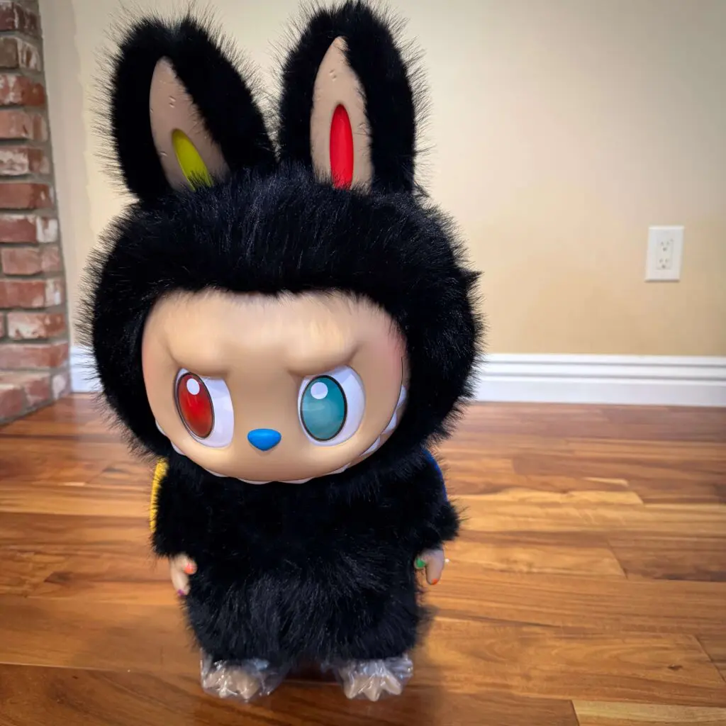 labubu zimomo 10th anniversary doll standing on wood floor in dining room