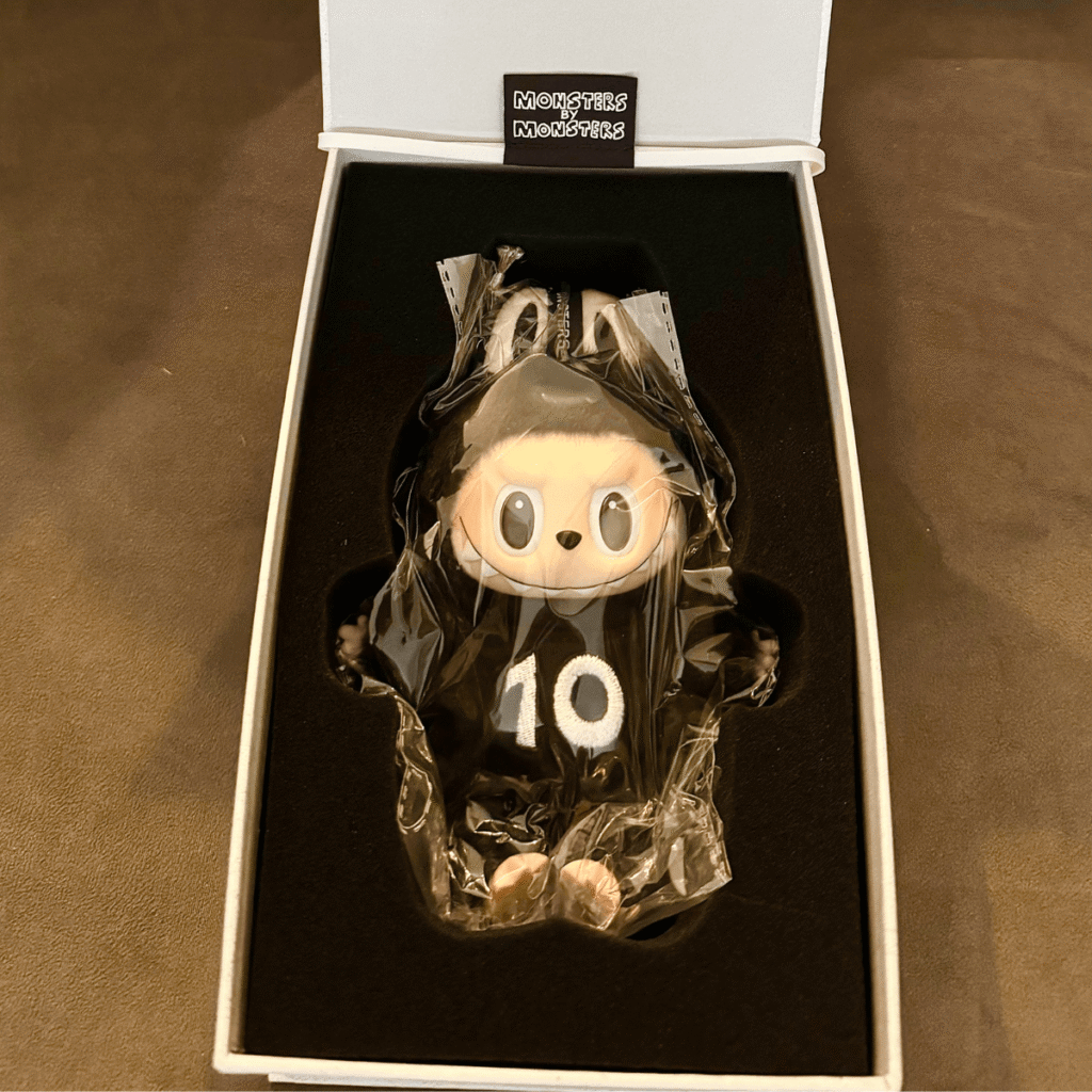 square crop of Labubu 10th anniversary exhibition limited edition keychain doll in original box packaging