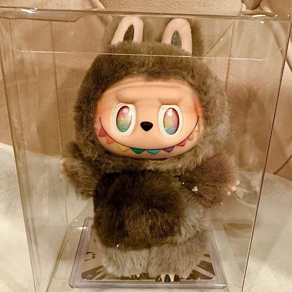 labubu big into energy secret ID inside an acrylic display case