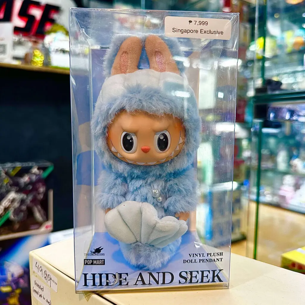 Labubu Hide and Seek Singapore-exclusive keychain doll on a store display inside box