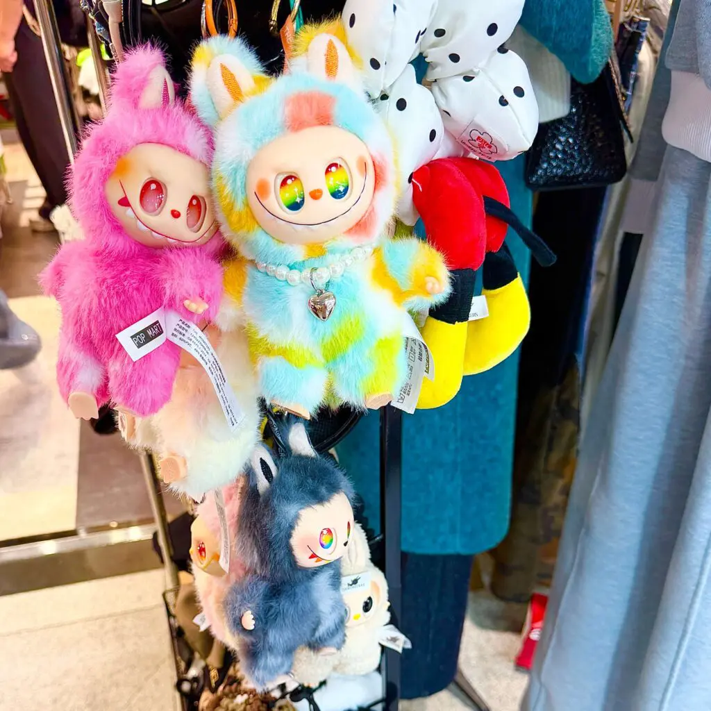 fluffy lafufu keychain dolls on a store display