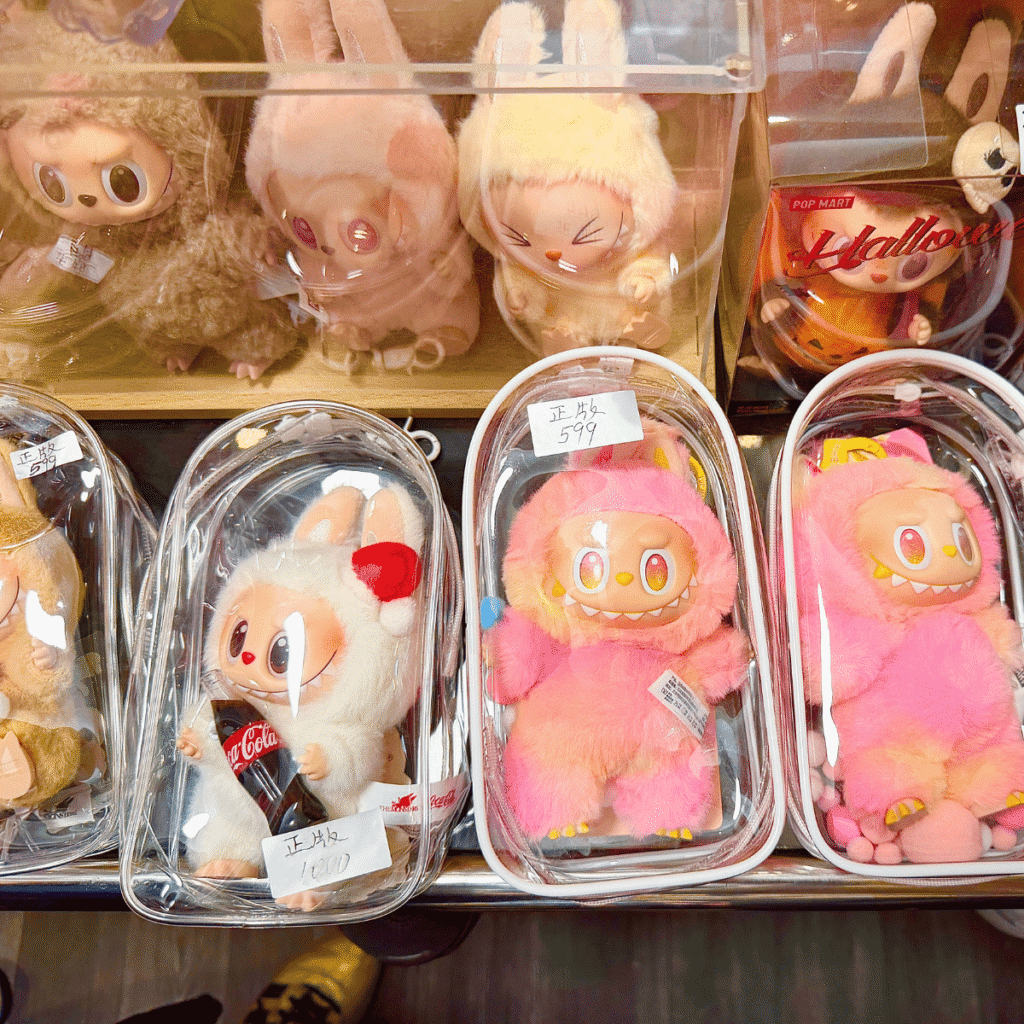 lafufu keychain dolls inside plastic and acrylic cases on a store display