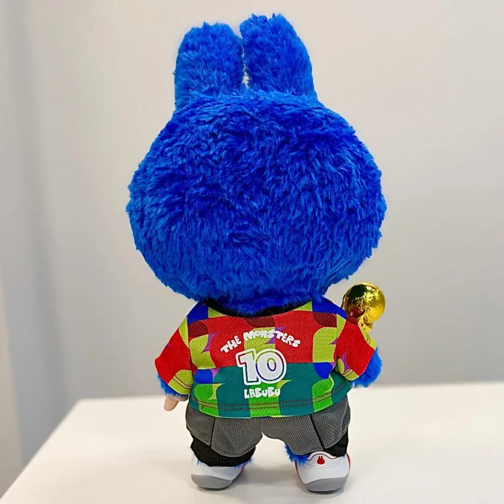 Close up of The Monsters x FIFAWorld Cup Catch the Win plush doll cable tie inside its protective plastic casing