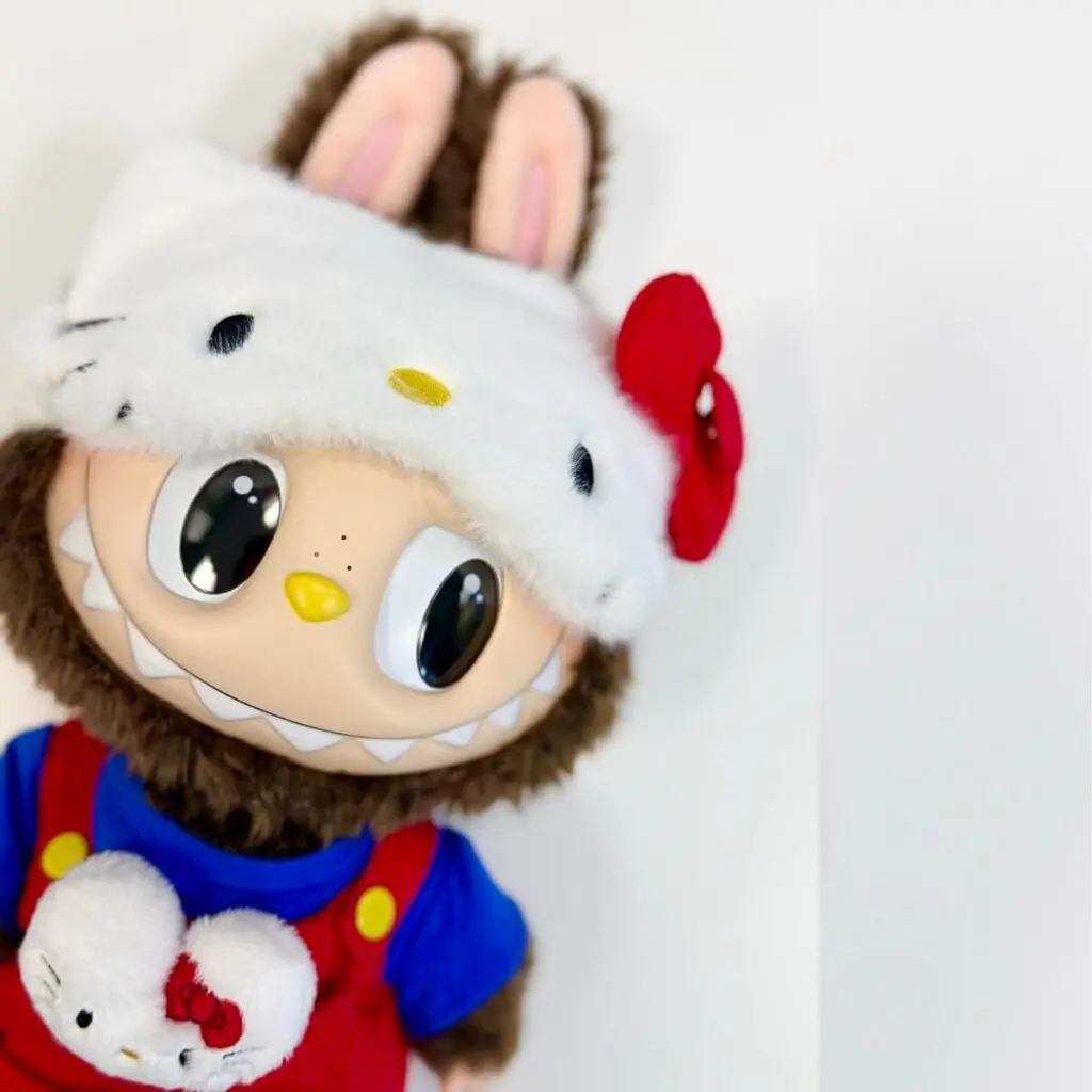 Close up of Labubu x Hello Kitty plush doll on a white background