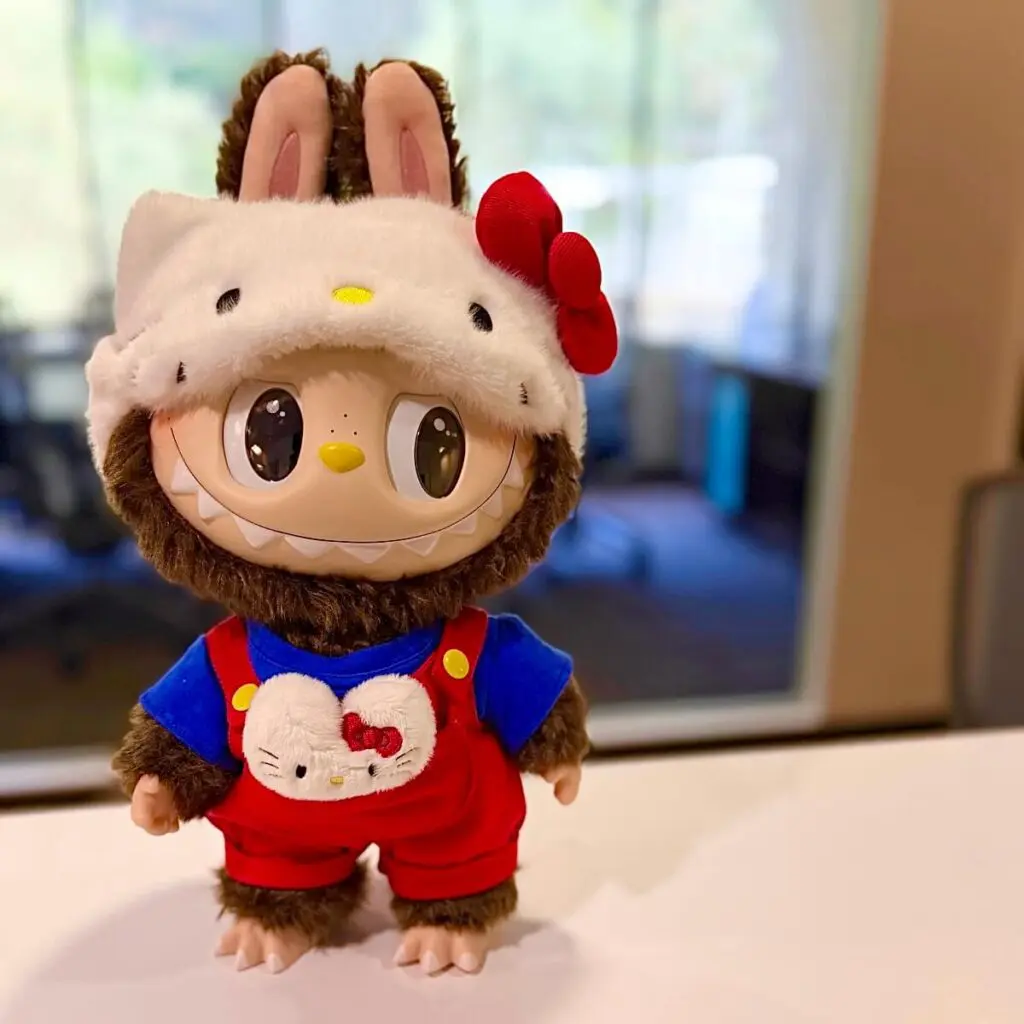 Labubu x Hello Kitty plush doll standing on a table