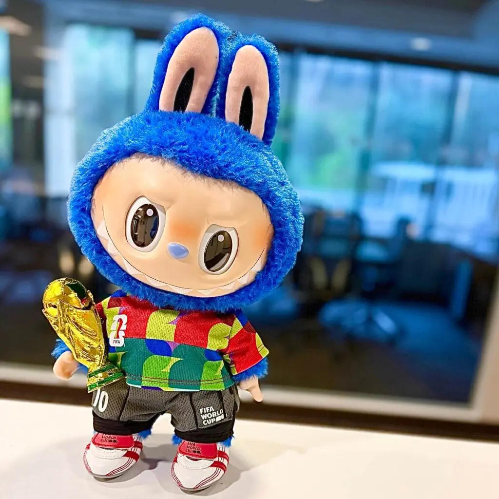 Close up of The Monsters x FIFAWorld Cup Catch the Win plush doll on a blurred background