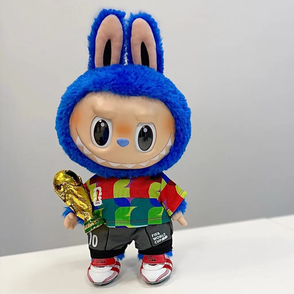 The Monsters x FIFAWorld Cup Catch the Win plush doll on a gray background