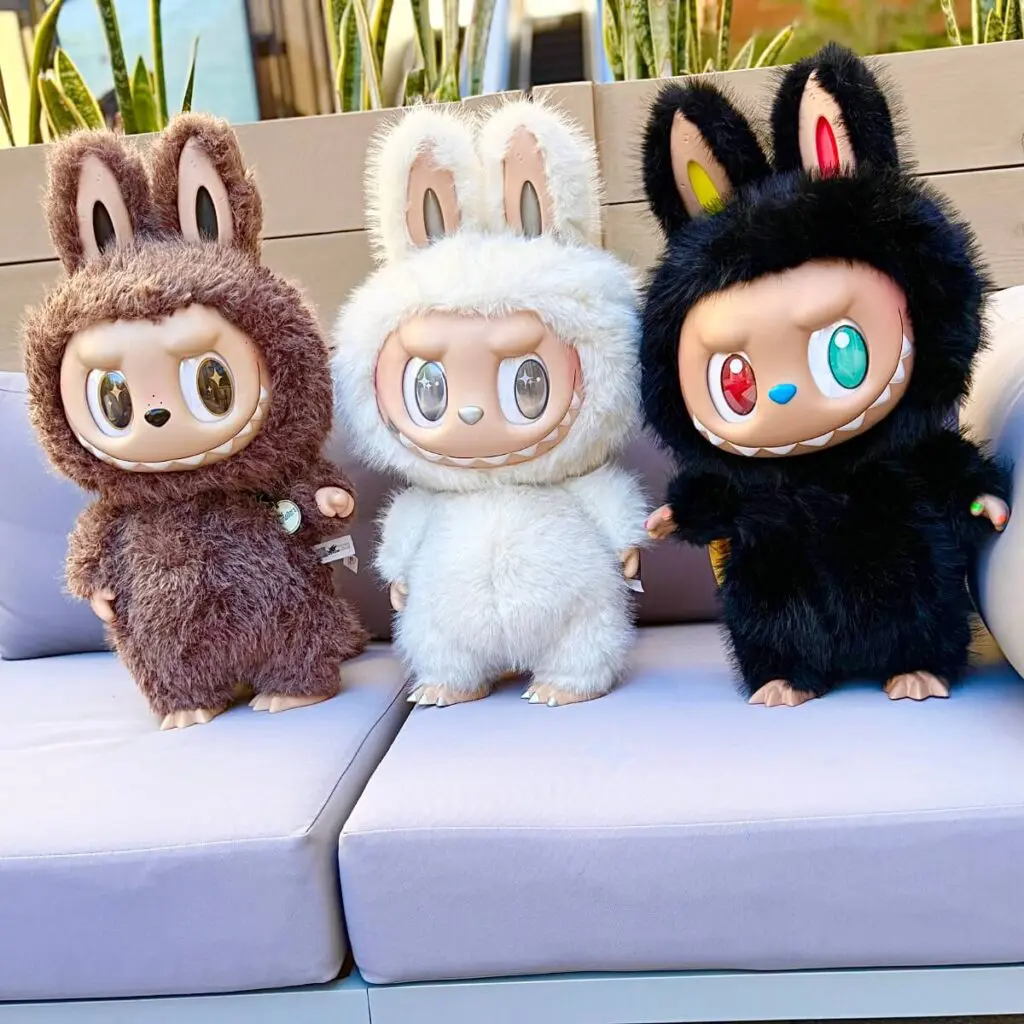 Zimomo I Found You, Angel in Clouds, and 10th Anniversary standing on a sofa