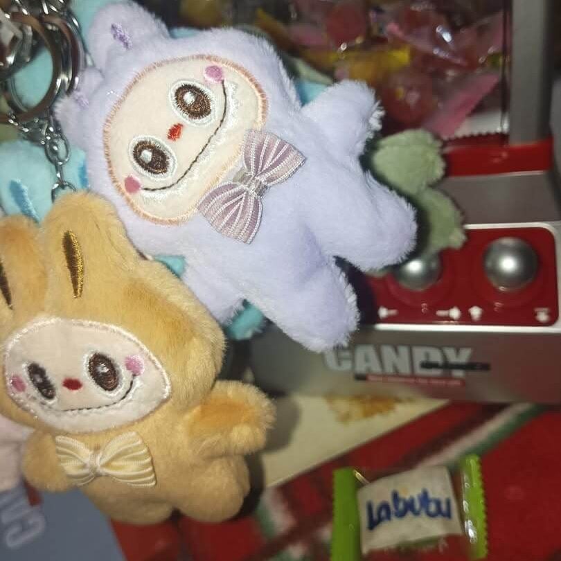 Poorly made fake Labubu sold in a mall in Manila, Philippines along with Labubu candy in the background