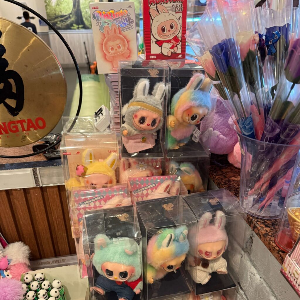 Fake Labubu dolls in clear plastic cases for sale at local Chinese restaurant