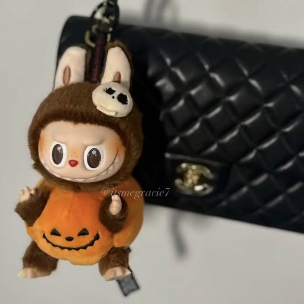 labubu halloween sitting pumpkin in black bag