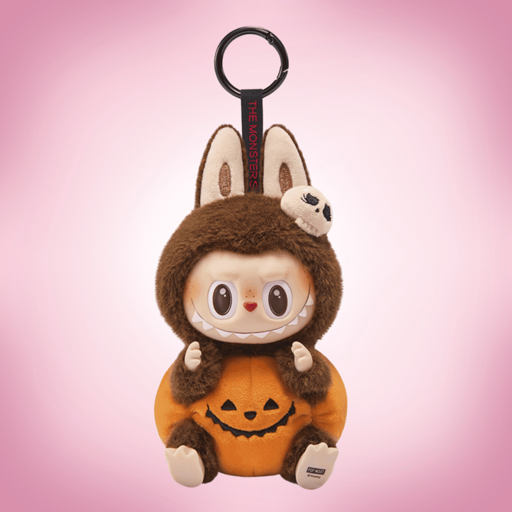 labubu halloween sitting pumpkin pink background